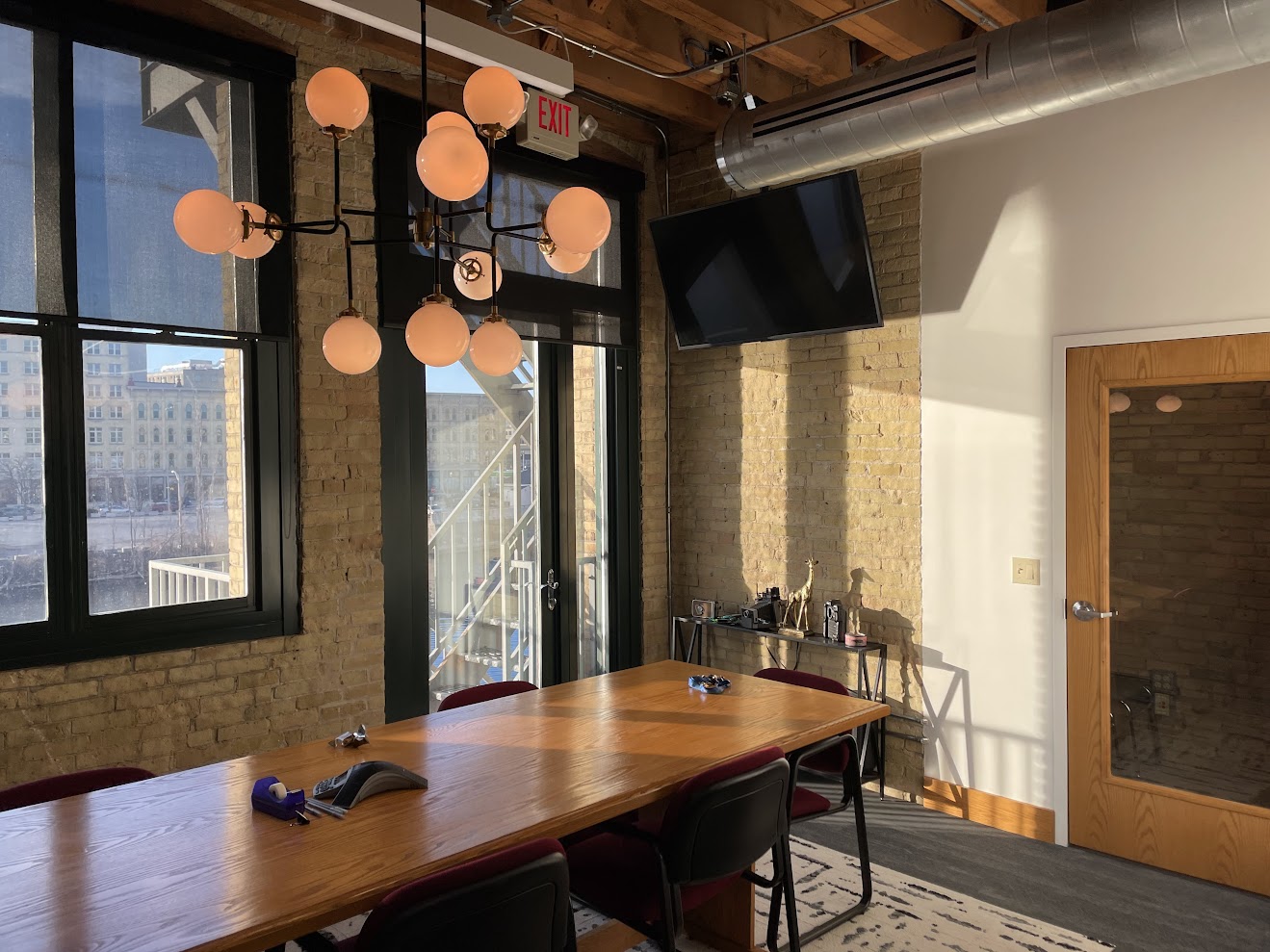 Giraffe's conference room with exposed brick and Milwaukee skyline view