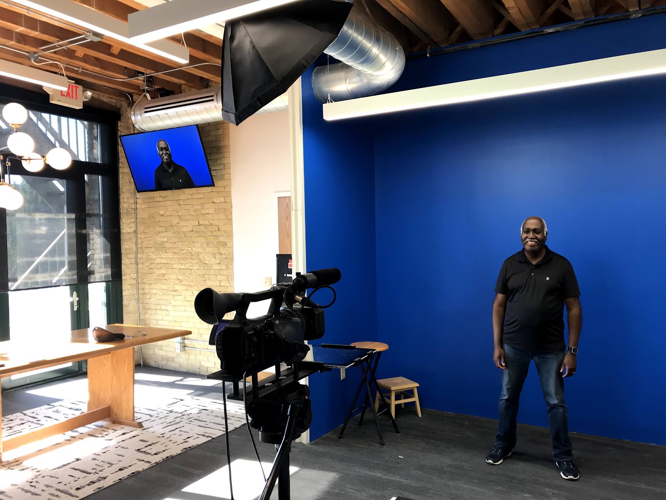 Talent on set in front of a blue screen at Giraffe's Milwaukee studio