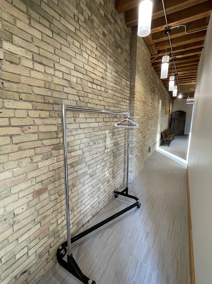 Wardrobe rack in hallway near brick archway